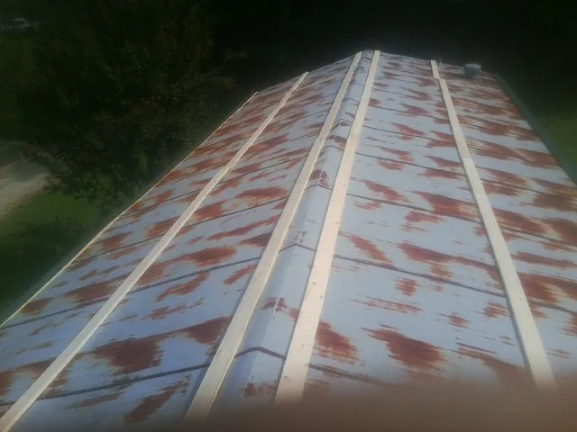 Rusted metal roof panels with new wood purlins before replacement — Storm Damage Roof Repair in Frenchtown by Roofing Brothers