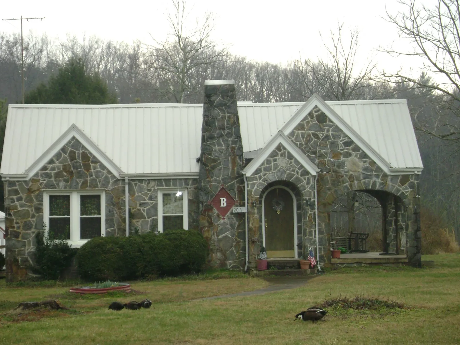 White metal roof on a stone cottage with steep gables in Frenchtown
